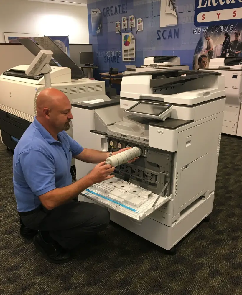 A technician from Electronic Office Systems in their showroom in Fairfield, NJ